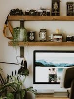 a computer monitor sitting on top of a wooden desk