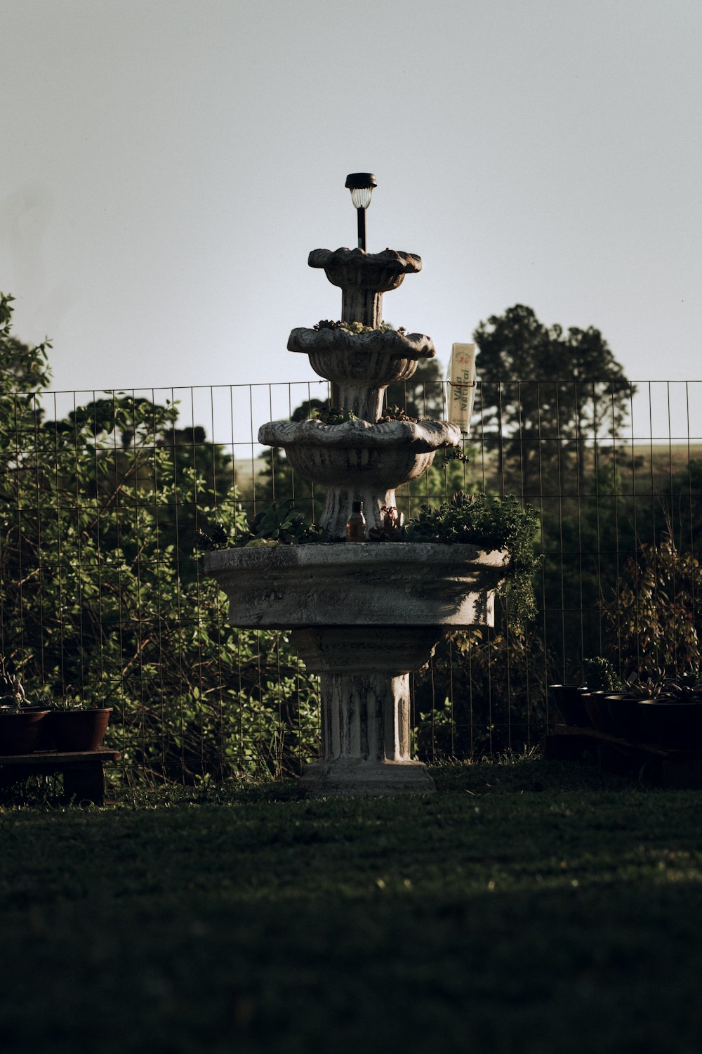 a water fountain in the middle of a park