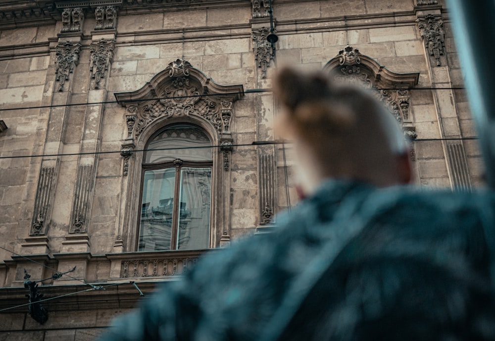 a man standing in front of a tall building