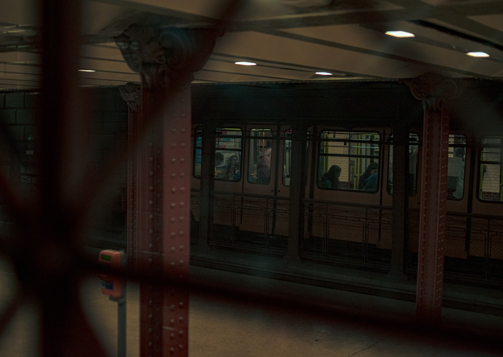 a subway car is seen through a fence