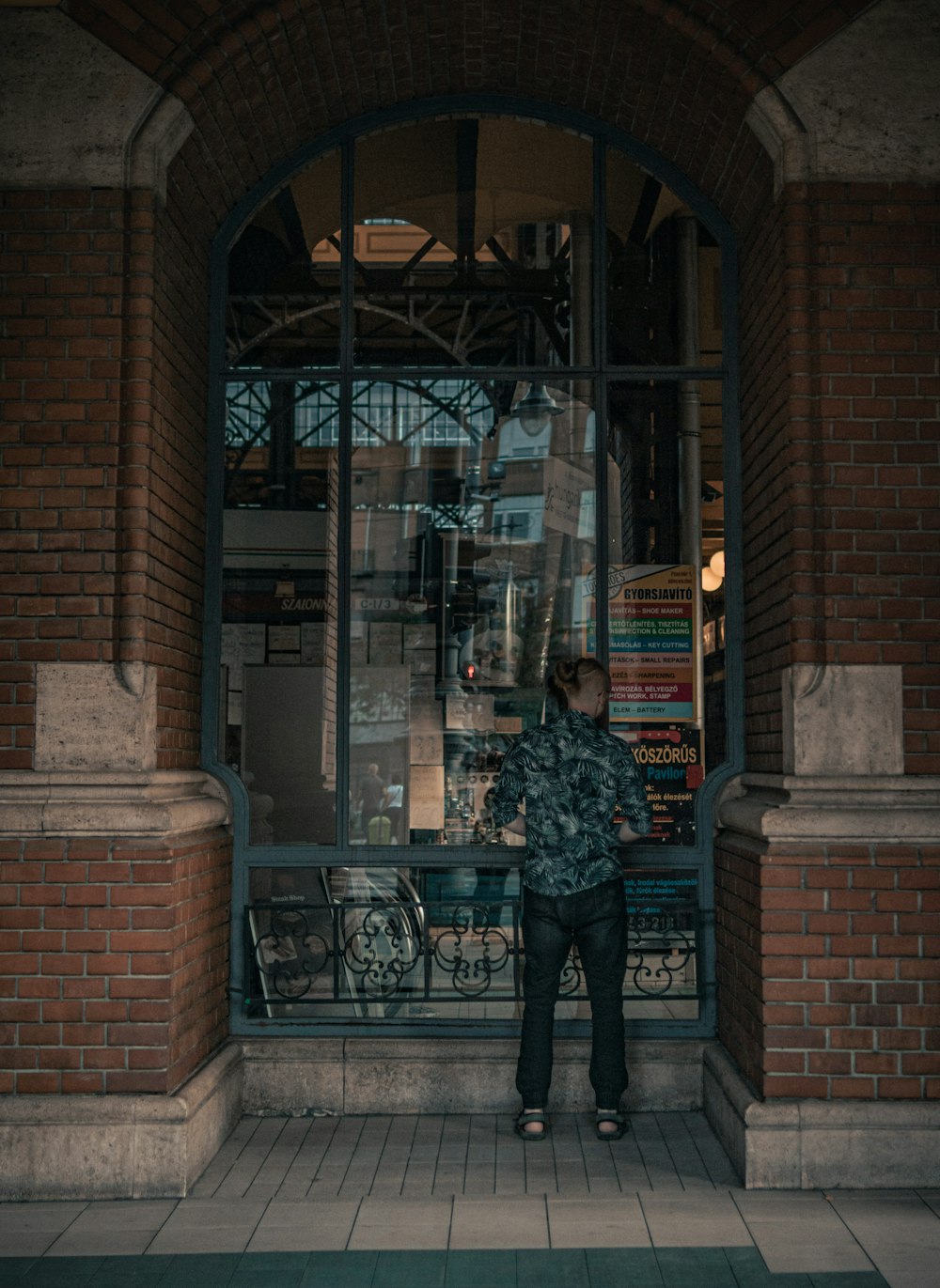 a man standing in front of a book store