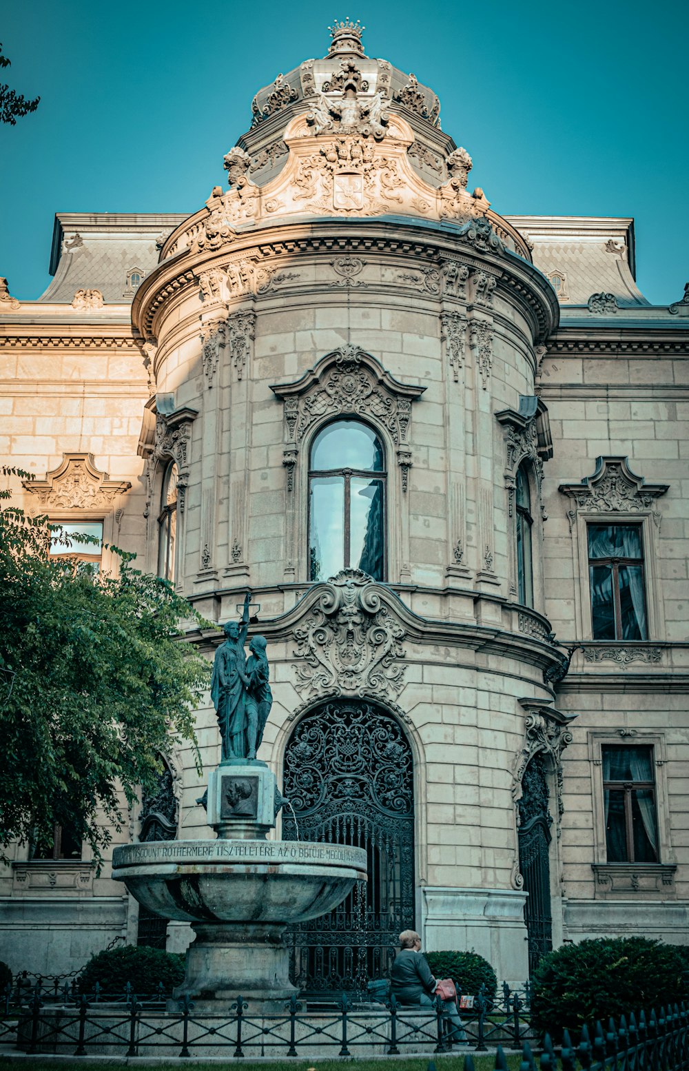 a large building with a fountain in front of it