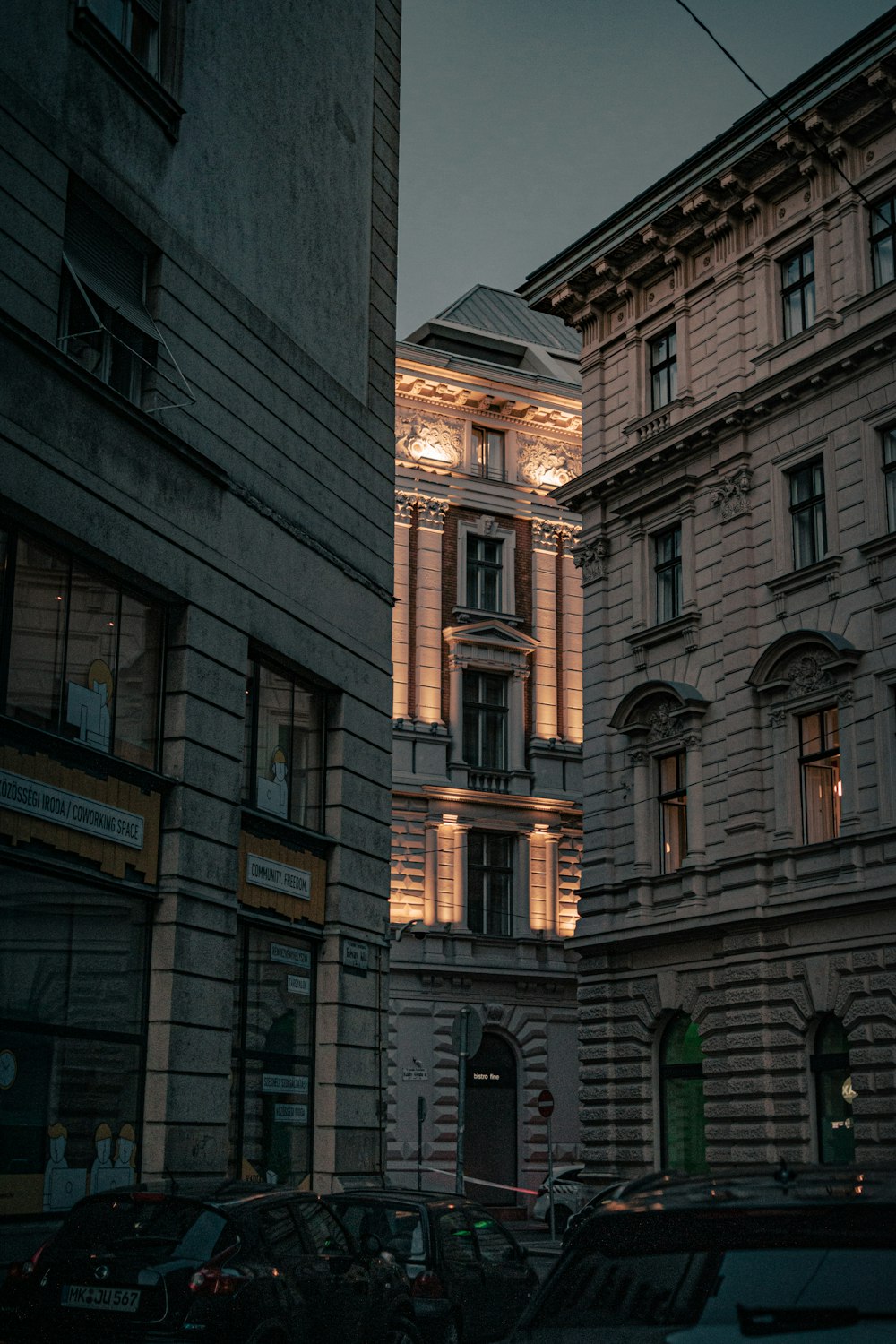 a city street at night with a clock tower in the background