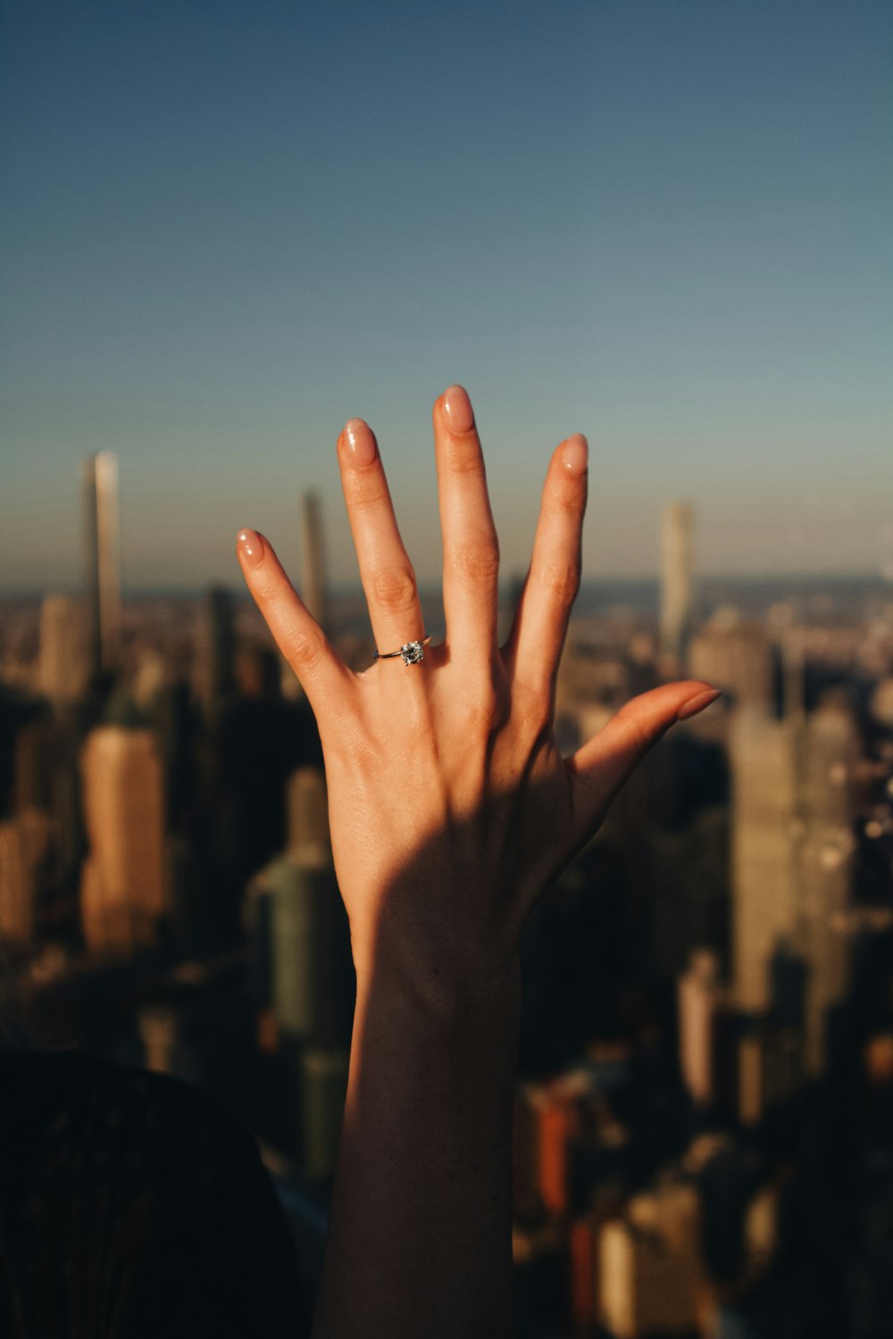 a person's hand with a ring on top of it
