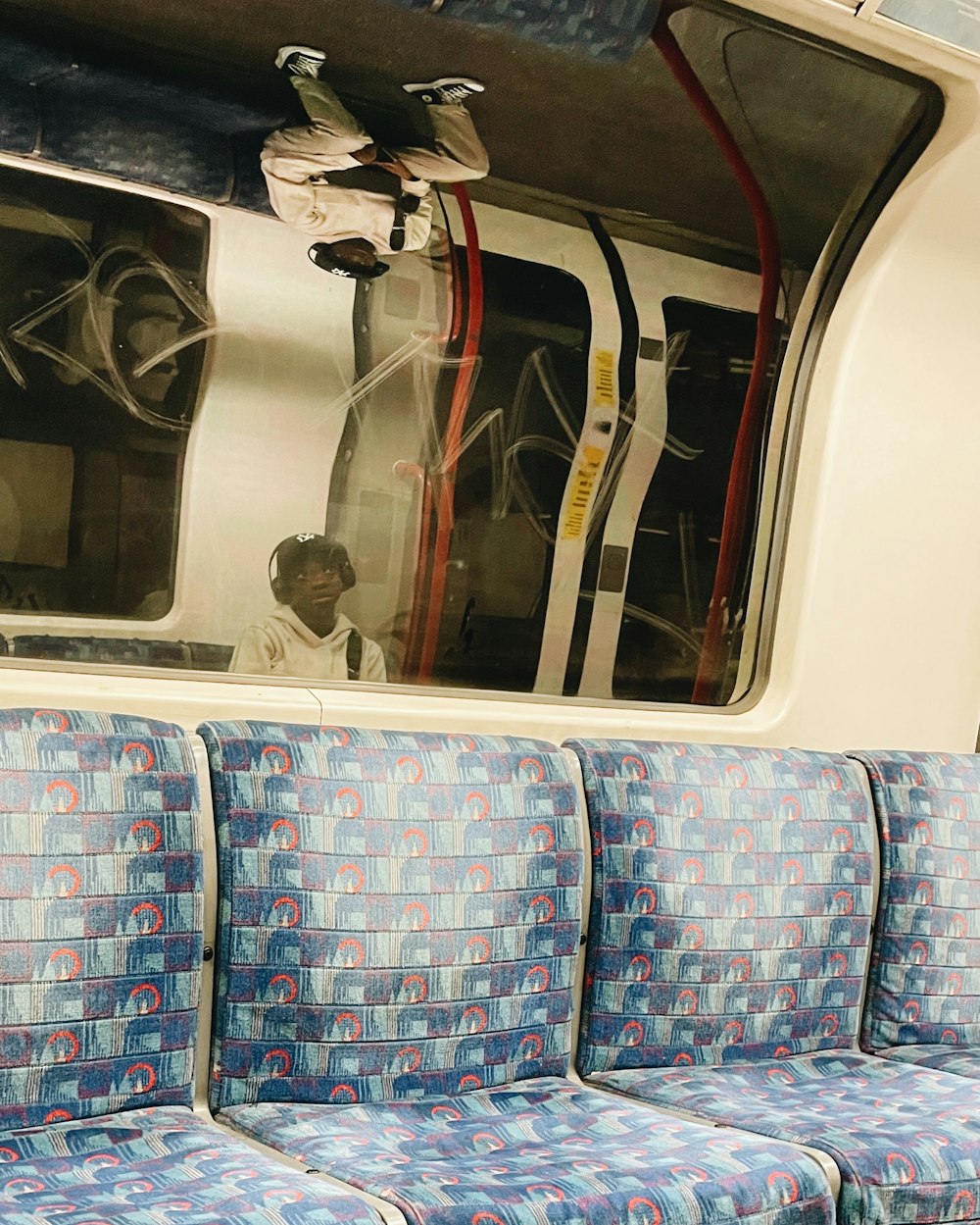 a man sitting on a train looking out the window