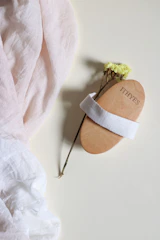 Soft goat hair baby brushes arranged neatly on a broken white surface with natural light.