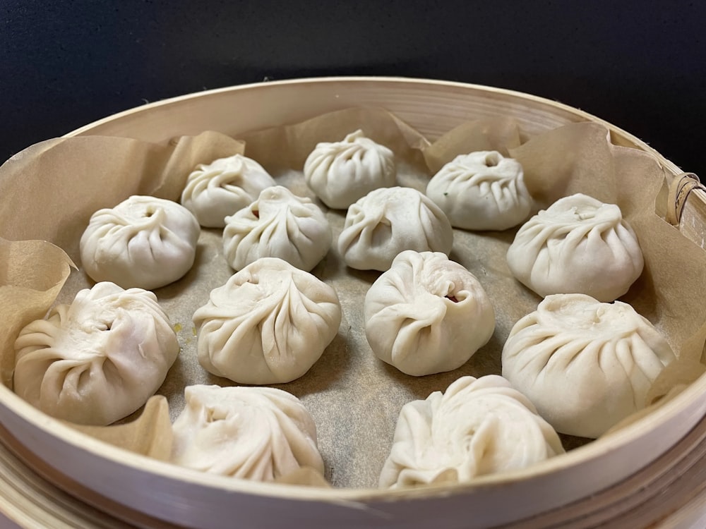 a pan filled with dumplings sitting on top of a table