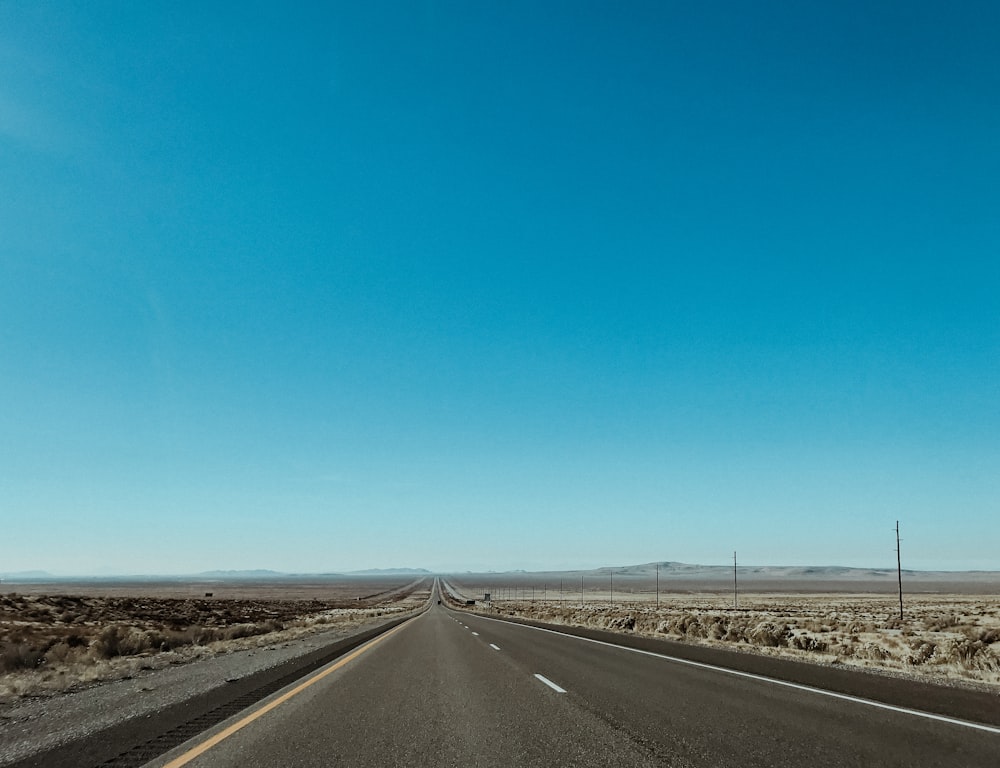 an empty highway in the middle of the desert