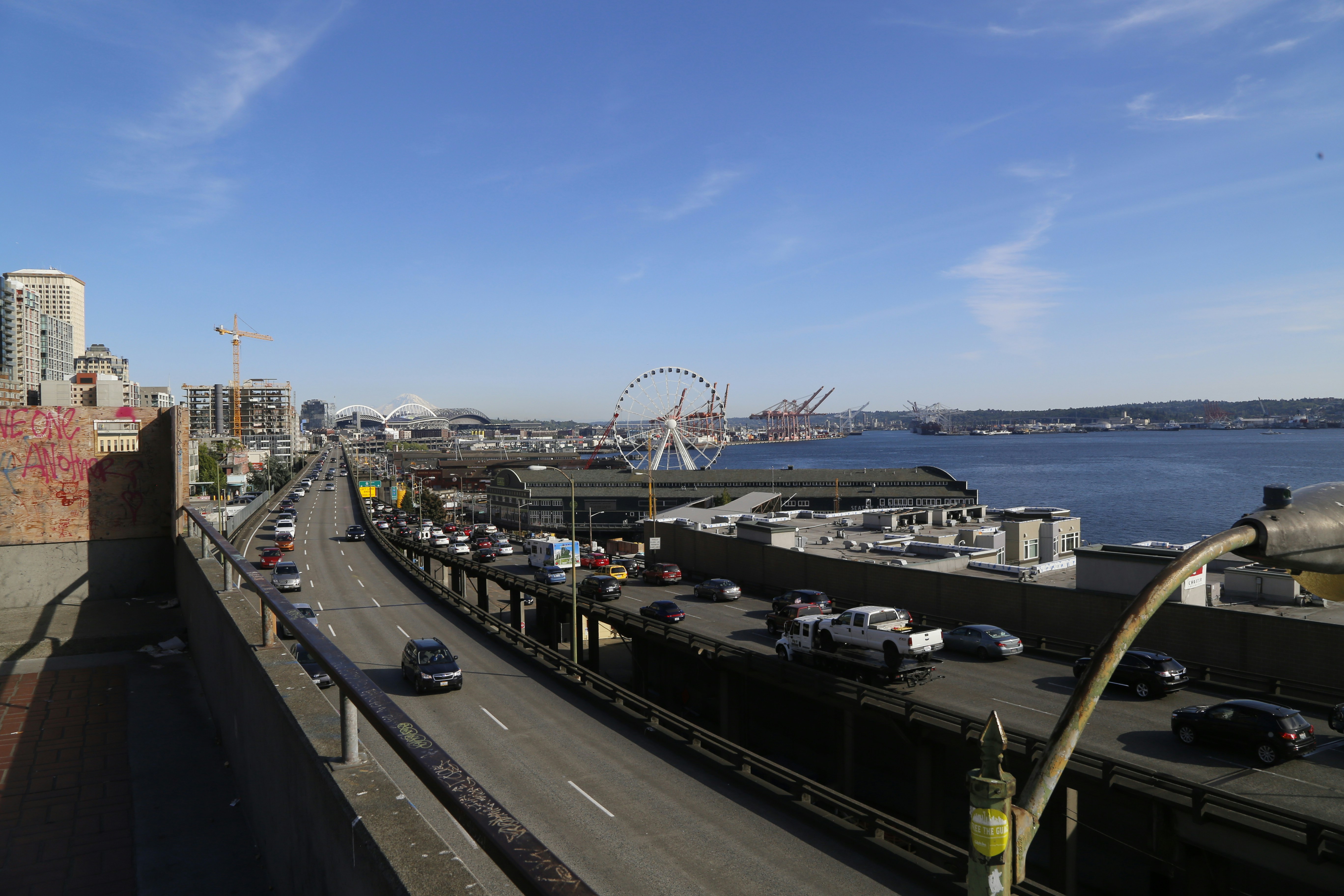 a view of a city street with a ferris wheel in the background, Seattle - Harbour / Waterfront