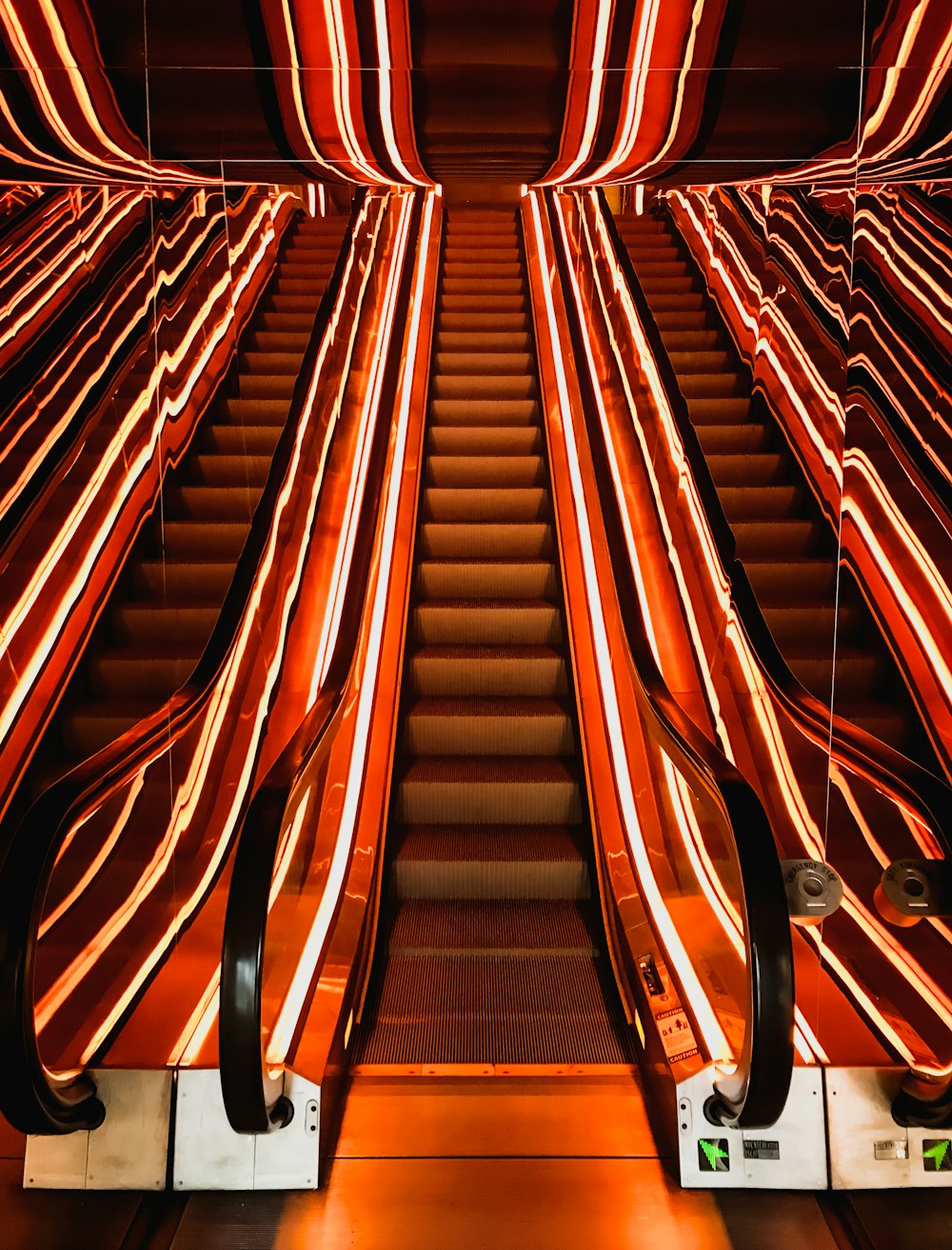 a set of escalators with red and white striped seats