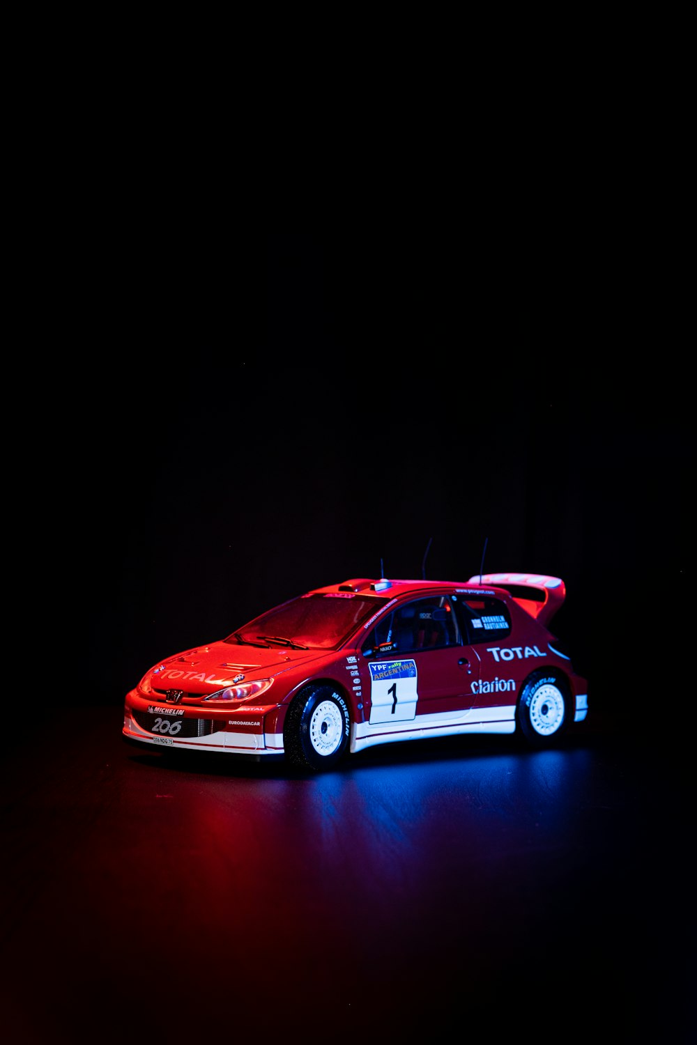 a red and white car on a black background