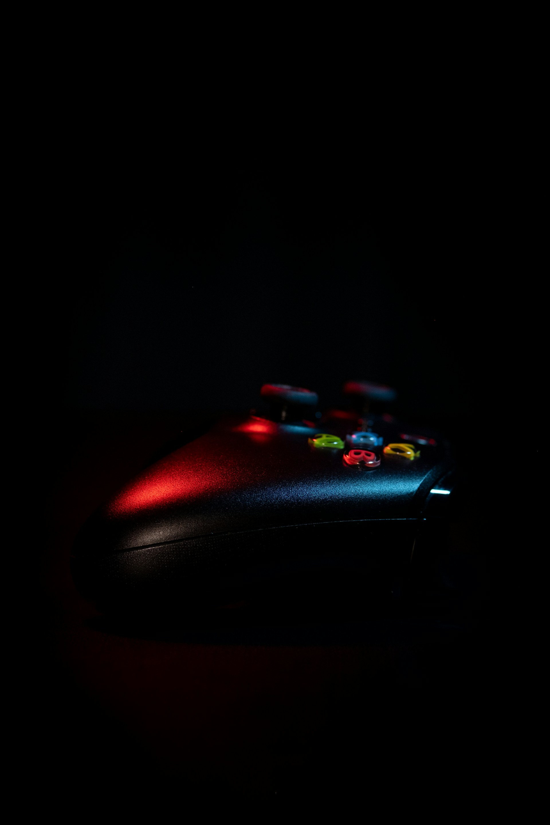 a close up of a video game controller in the dark