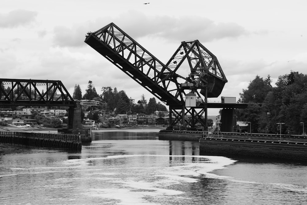 a black and white photo of a bridge over a river