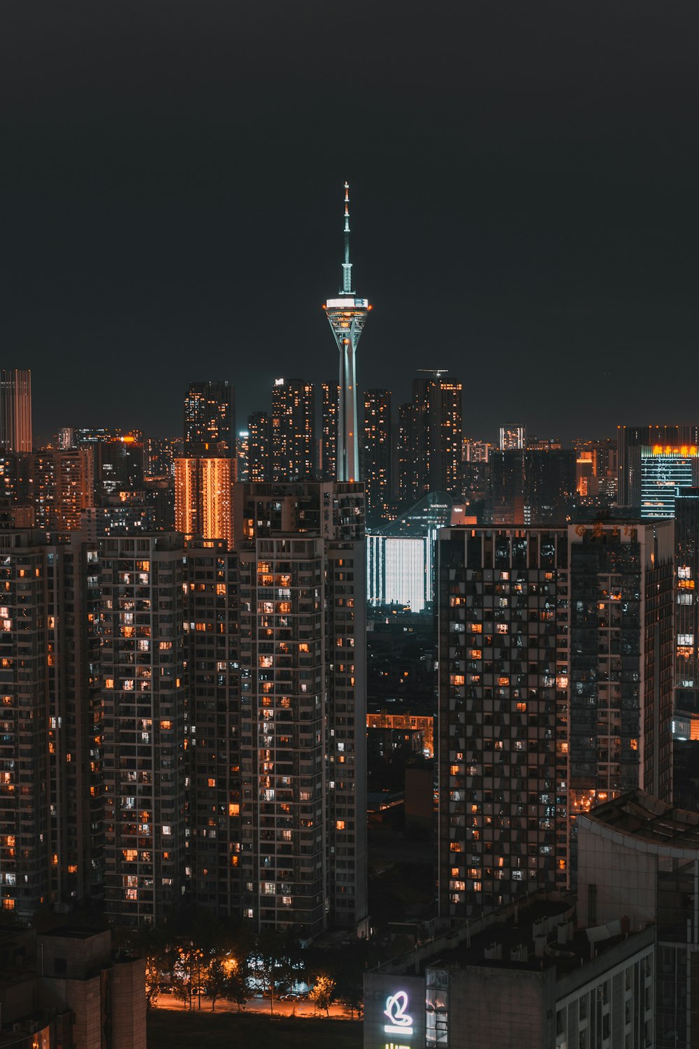 a city skyline at night with tall buildings