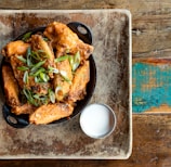 a plate of food on a table next to a glass of milk