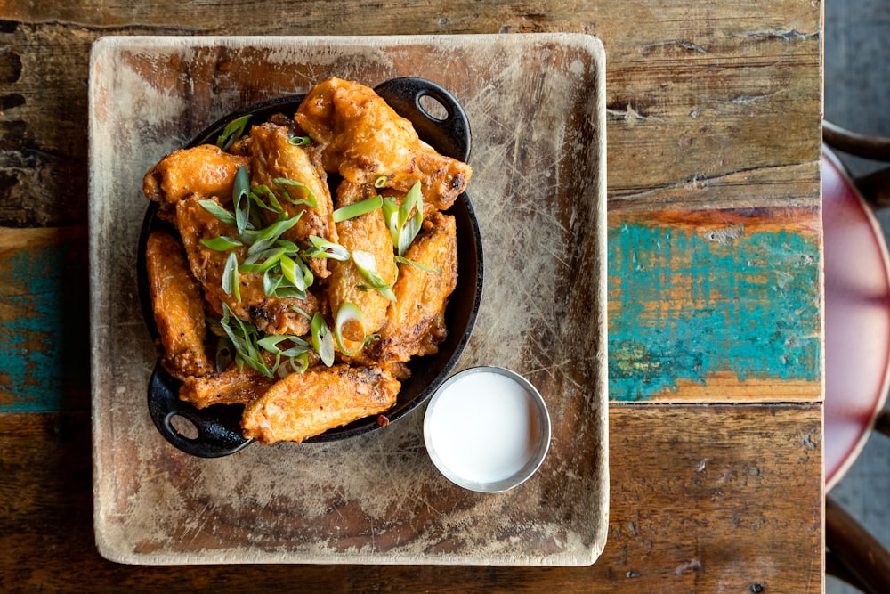 a plate of food on a table next to a glass of milk