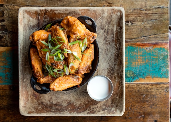 a plate of food on a table next to a glass of milk