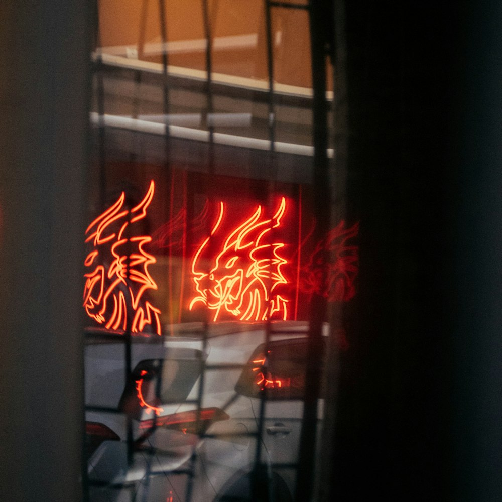 a reflection of a neon sign in a window