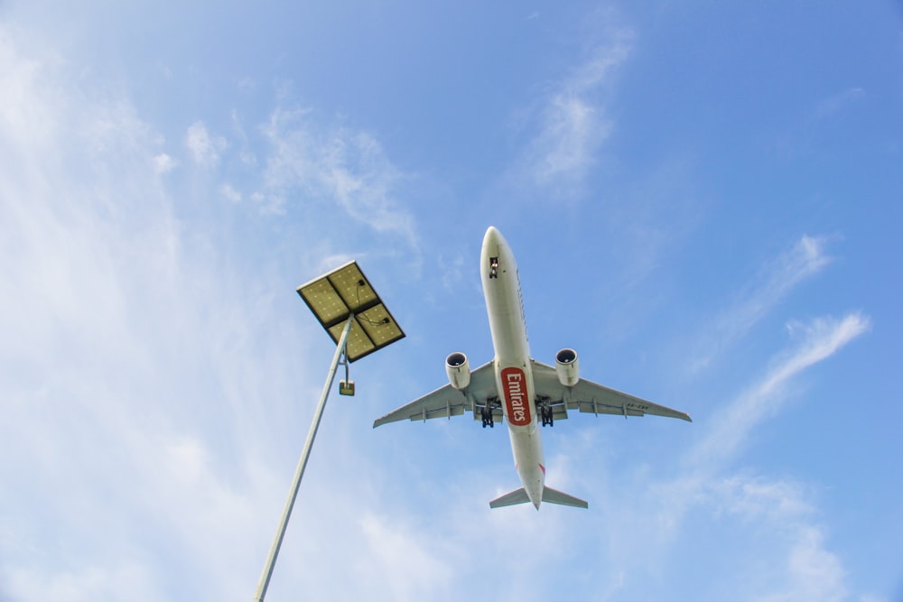 a large jetliner flying through a blue sky