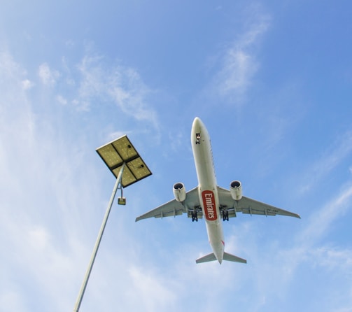 a large jetliner flying through a blue sky