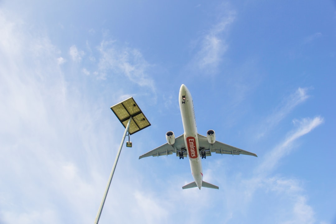 a large jetliner flying through a blue sky,