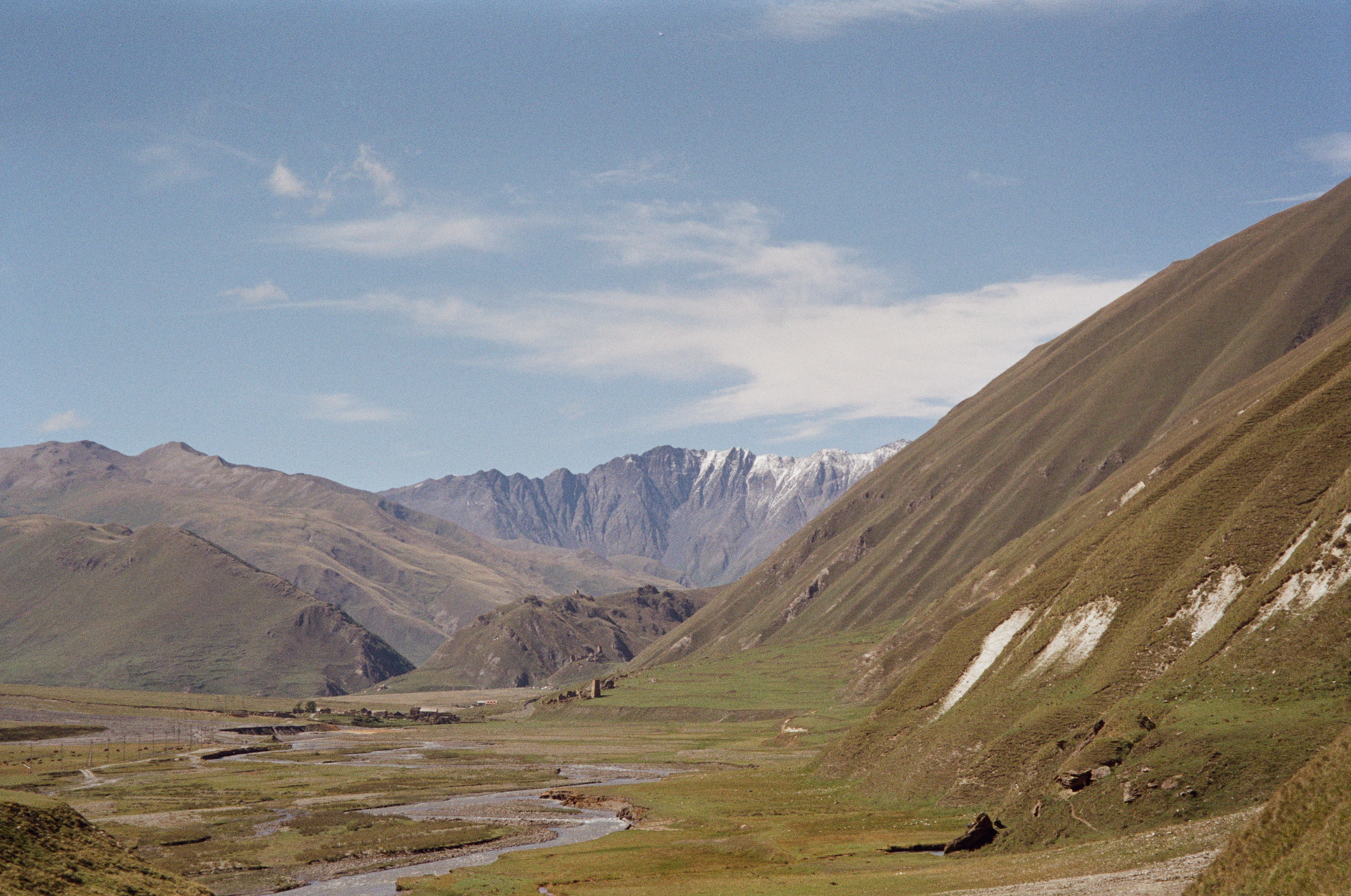 The broad Truso valley, its braided river and the mountains beyond