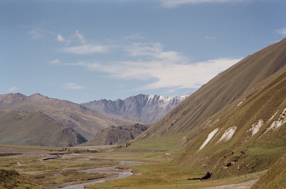 a view of a valley with mountains in the background