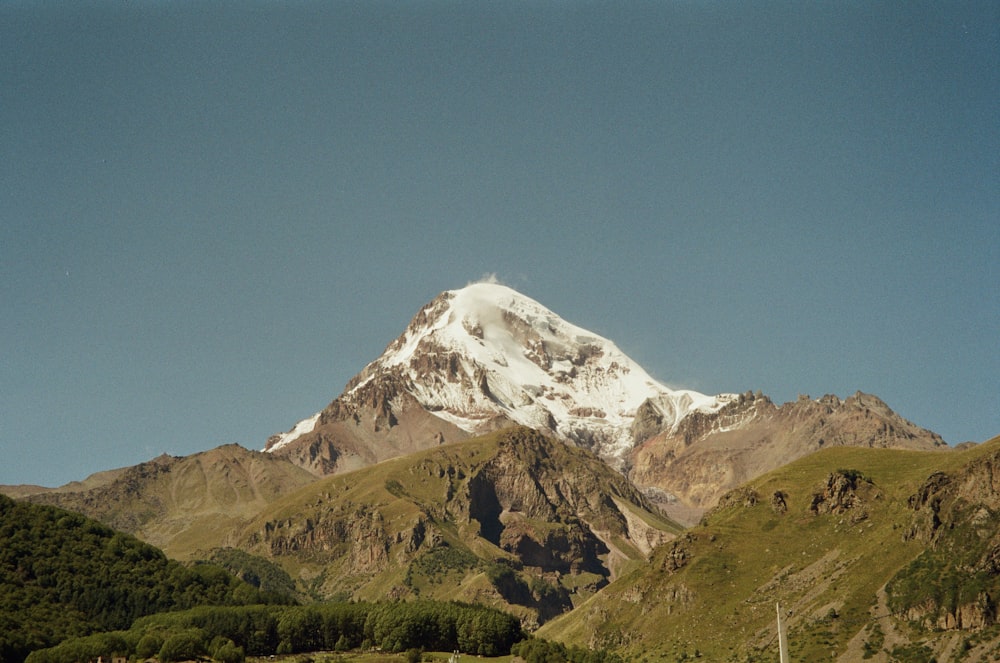 a snow covered mountain in the middle of the day