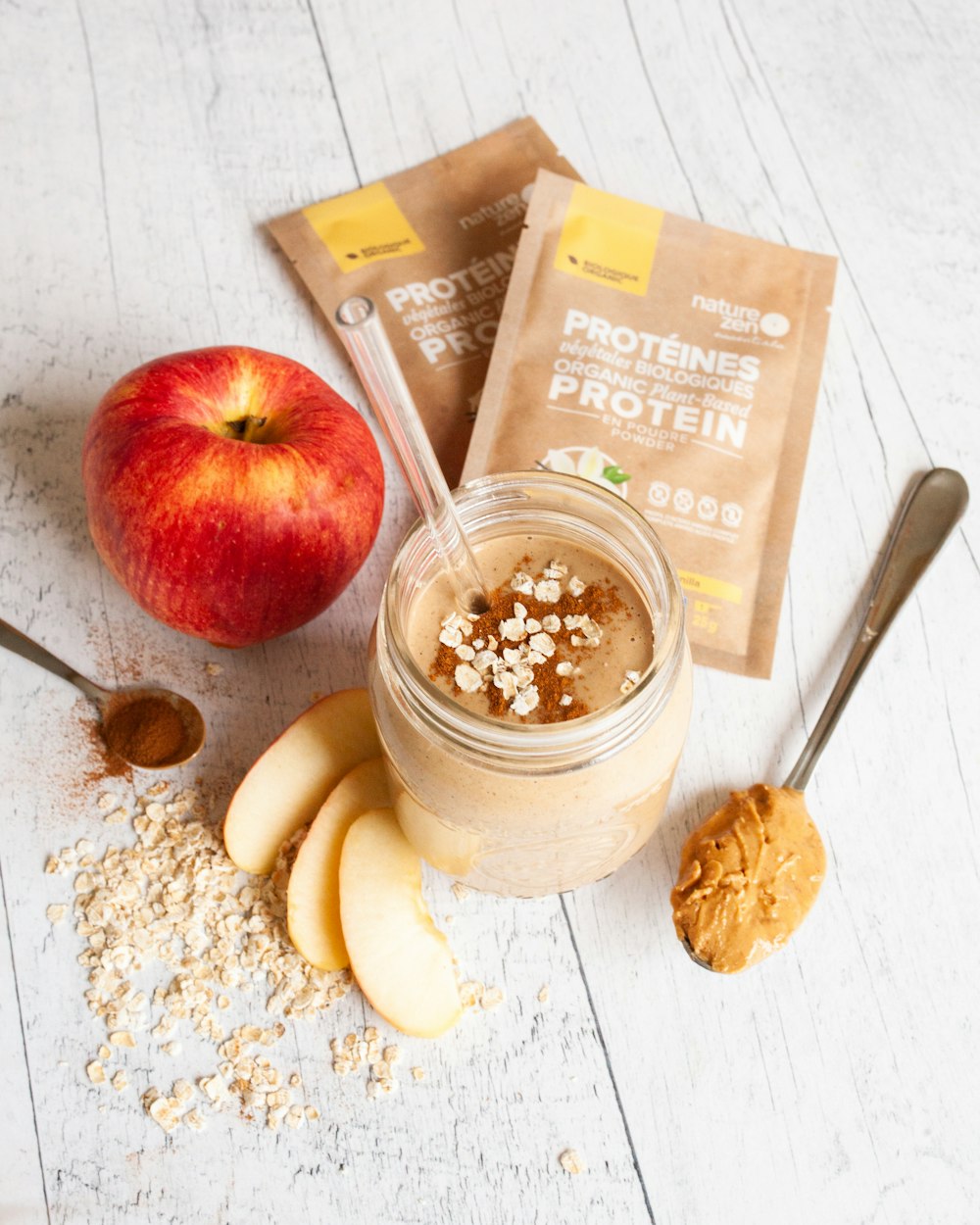 an apple, oatmeal, and peanut butter smoothie in a jar