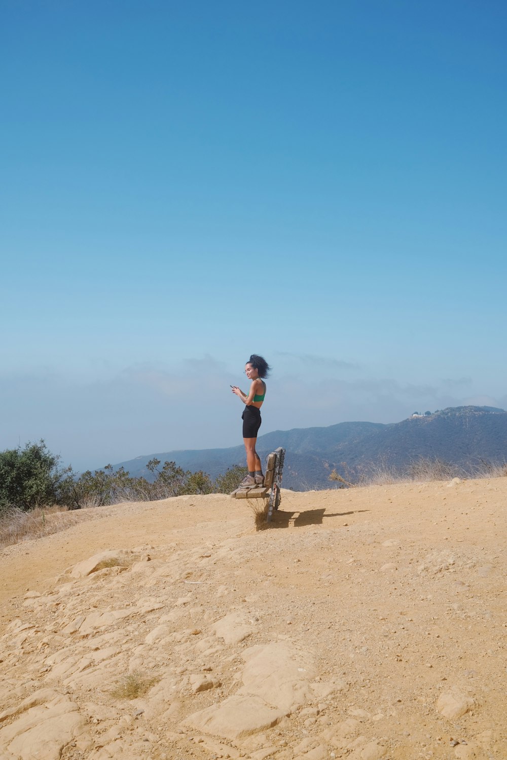 a person riding a skateboard on a dirt road