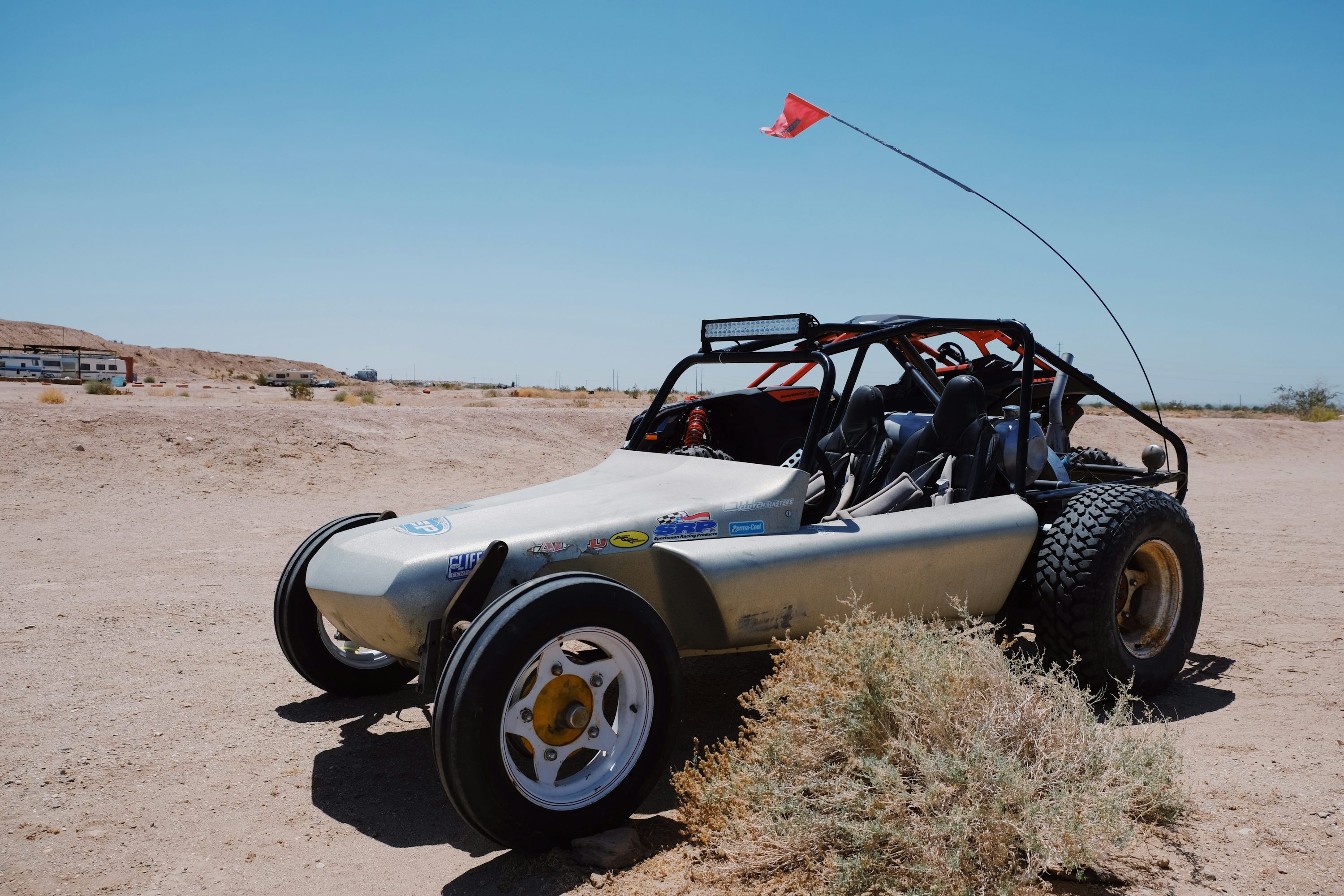 a dune buggy is parked in the desert