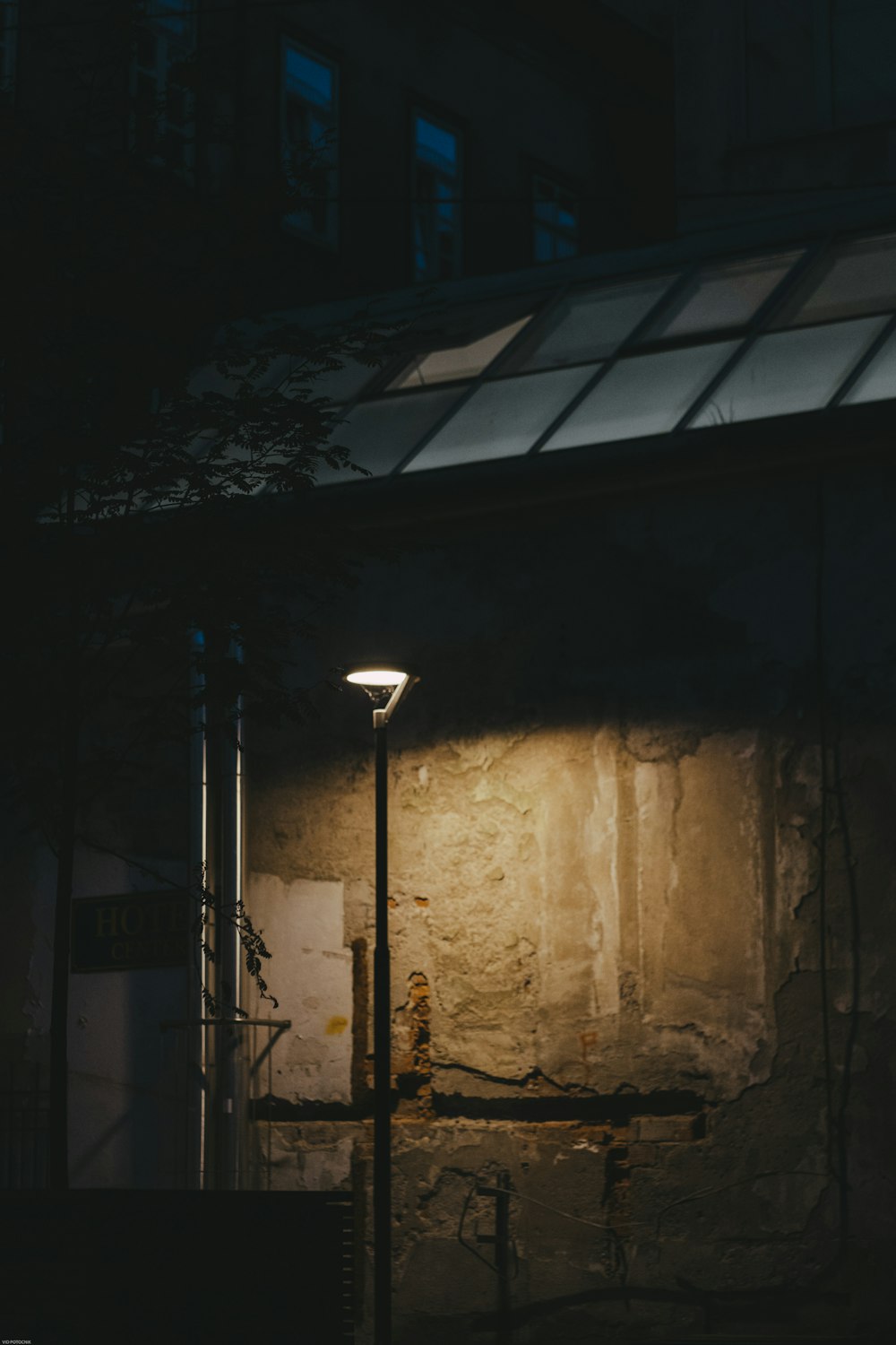 a street light sitting next to a building
