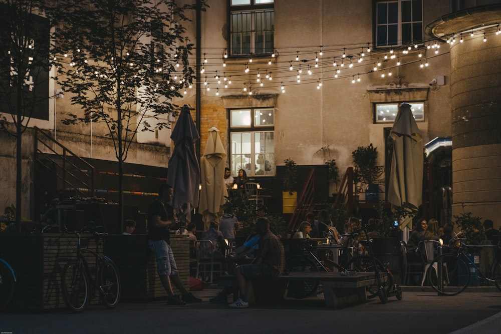 a group of people sitting outside of a building