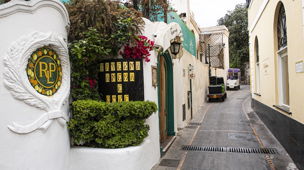 a narrow street with a sign on the side of it