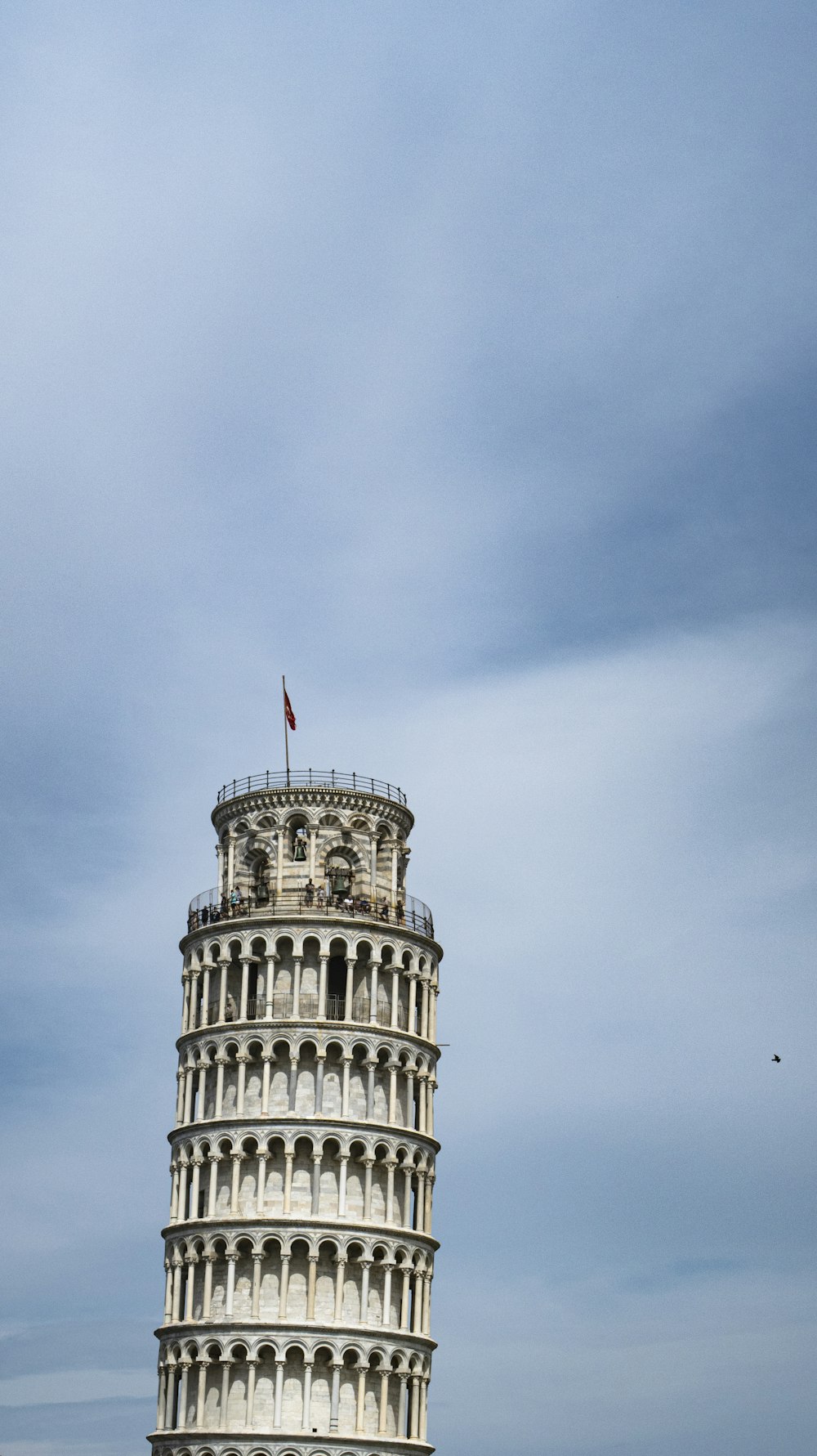 a tall tower with a flag on top of it