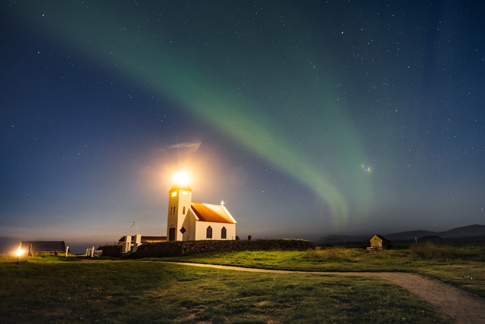 a church with a green aurora light in the sky