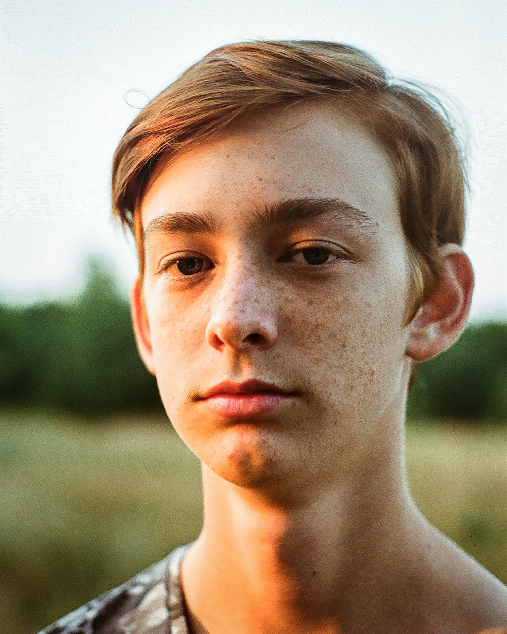 a young man with freckles on his face