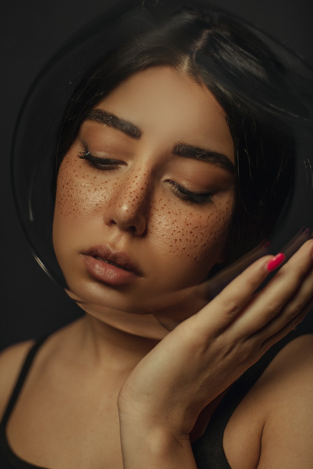 a woman with freckles on her face holding a cell phone