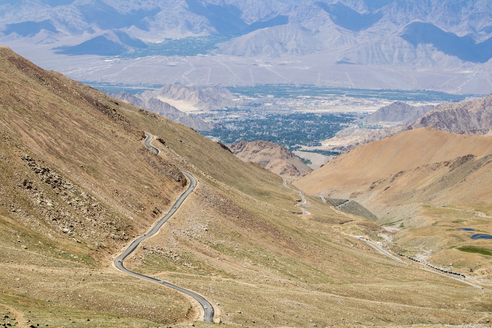 a winding road in the middle of a mountain range