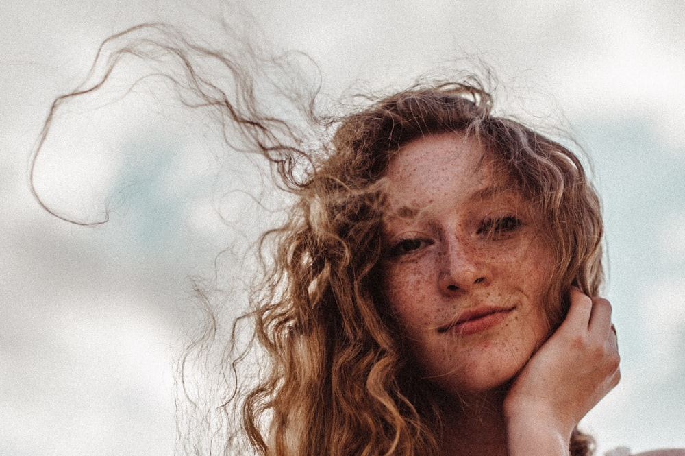 a woman with freckled hair is posing for a picture