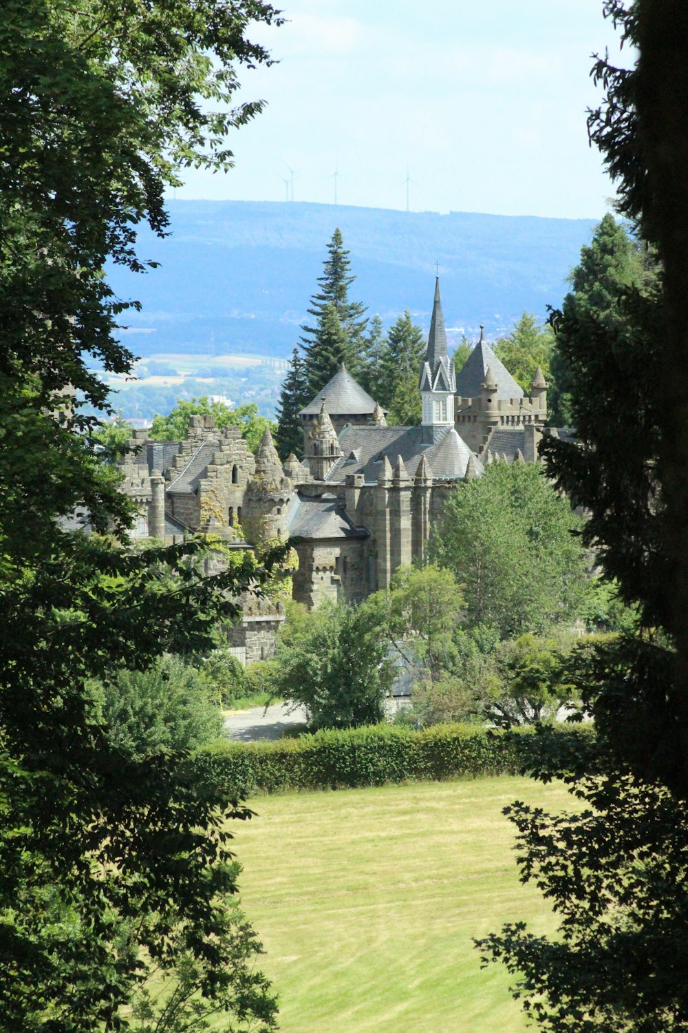 a view of a castle through some trees