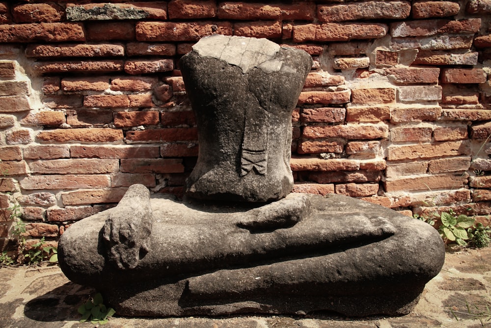 a stone statue of a person laying down