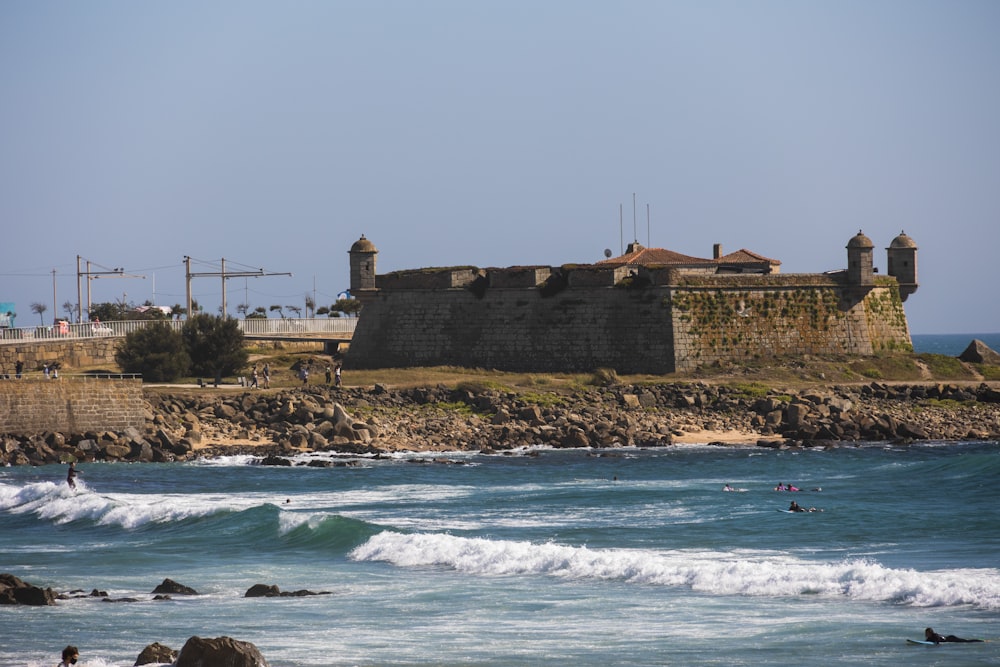 a view of a beach with a castle in the background