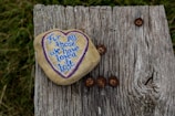 a heart shaped rock with a message written on it