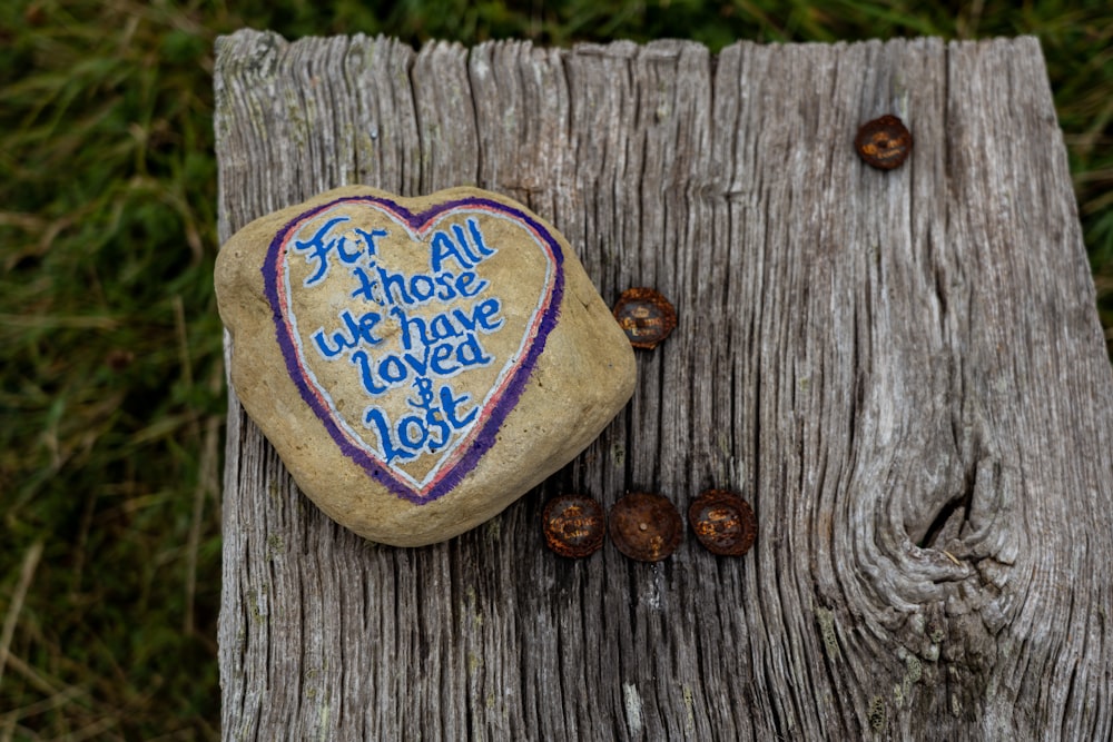 a heart shaped rock with a message written on it