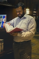 a man reading a book in a library