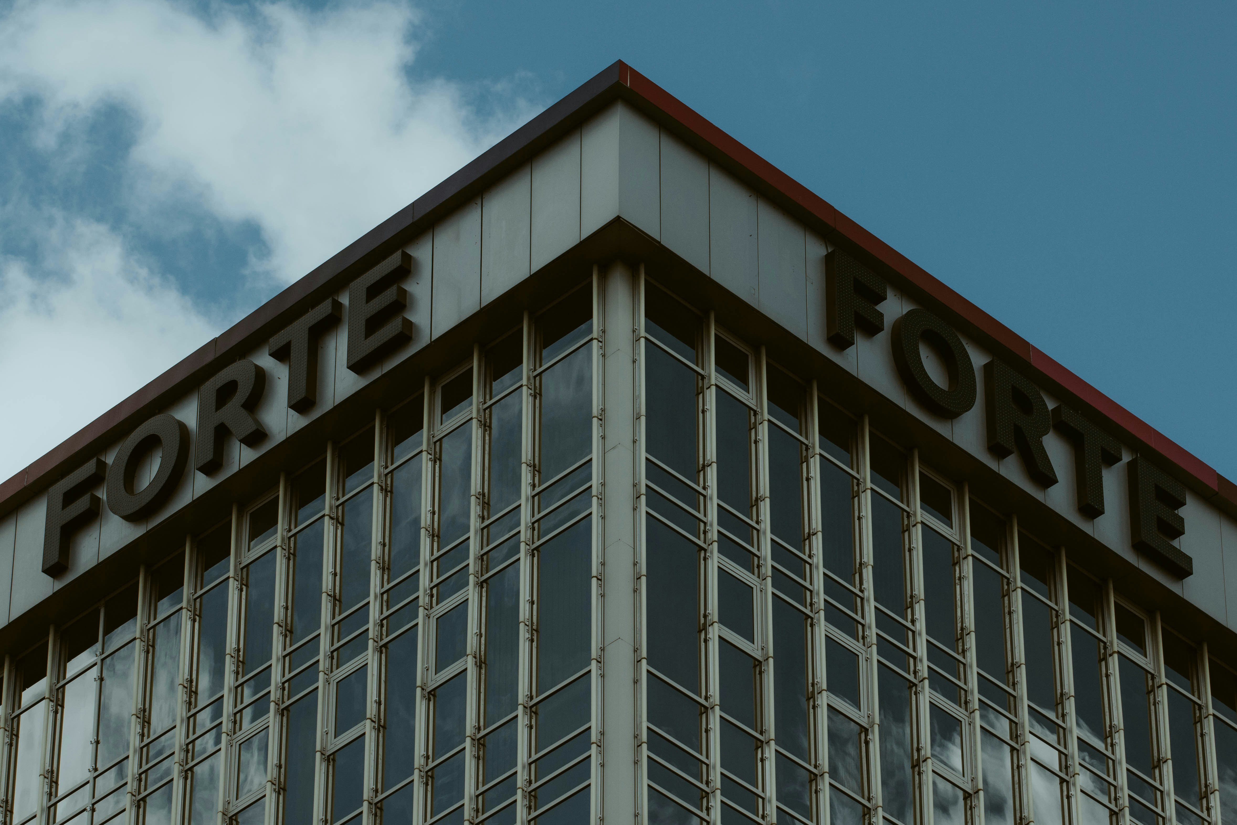 a tall building with a sign on top of it