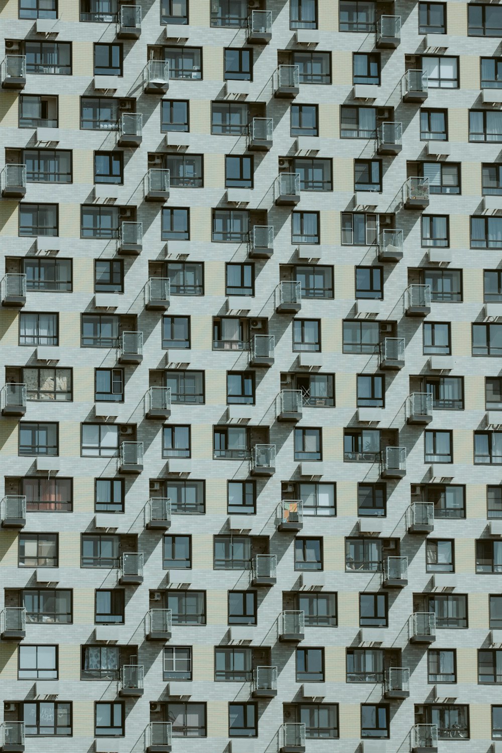 a very tall building with many windows and balconies