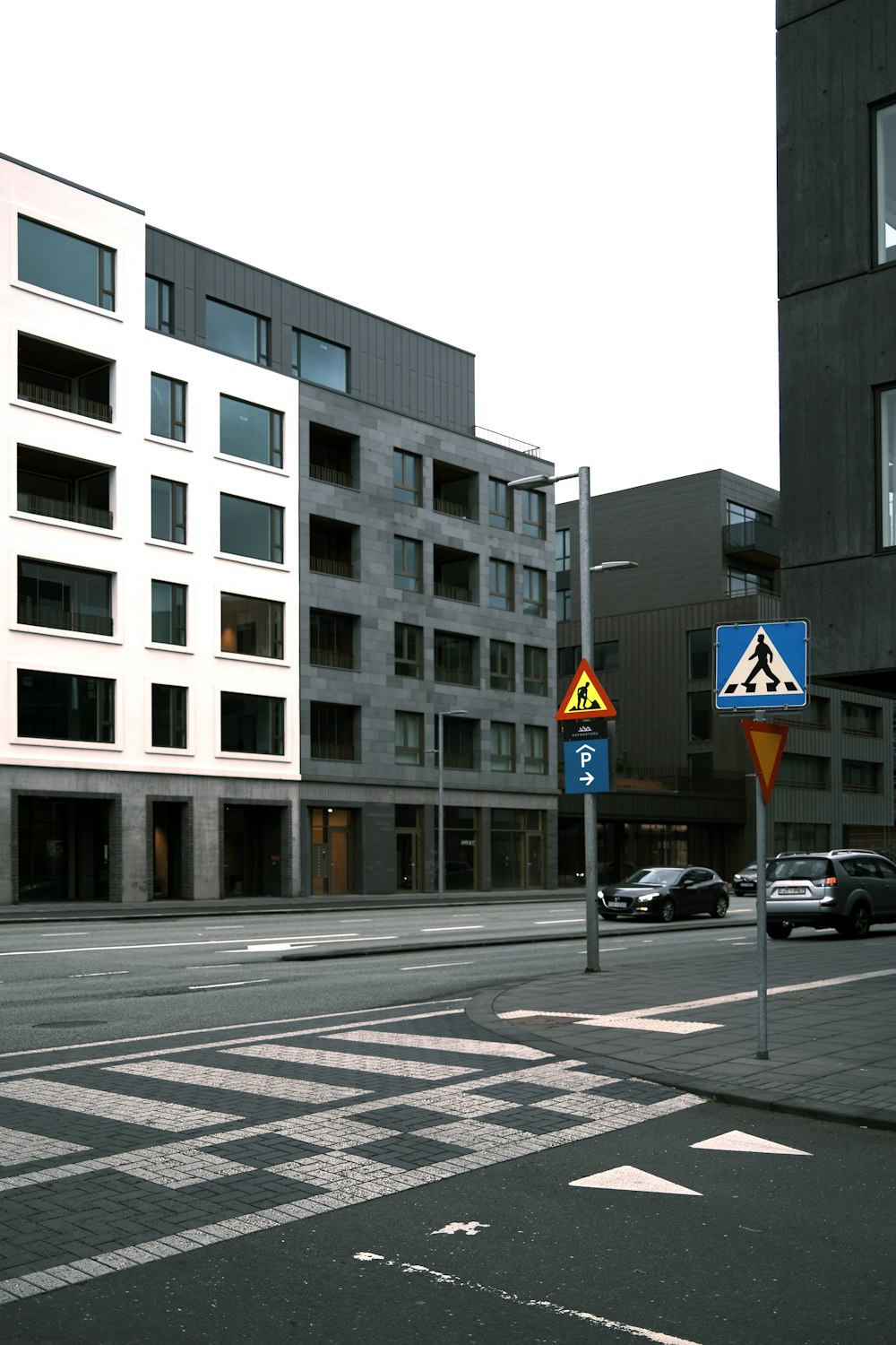 a city street with a few cars parked on the side of the road