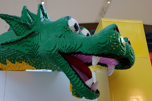 A playful green dragon with big eyes and curled tail, perfect for kids